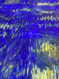 Vertical oil brushstrokes of mostly blue and some yellow paint.